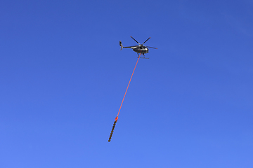 Image showing Heliwest helicopter and Aerial Saw for Trimming Trees