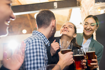 Image showing Happy co-workers celebrating corporate event after tensioned work day. Look delighted, friendly, cheerful