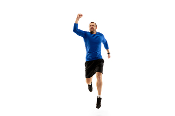 Image showing Caucasian professional runner, jogger training isolated on white studio background in fire