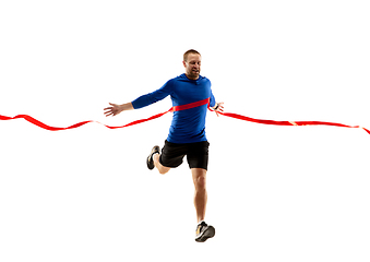 Image showing Caucasian professional runner, jogger training isolated on white studio background in fire