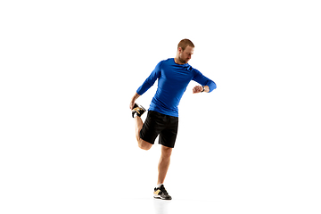 Image showing Caucasian professional runner, jogger training isolated on white studio background in fire