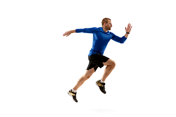 Image showing Caucasian professional runner, jogger training isolated on white studio background in fire