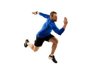 Image showing Caucasian professional runner, jogger training isolated on white studio background in fire