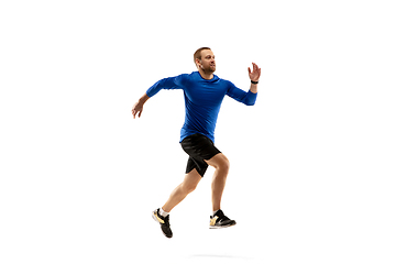 Image showing Caucasian professional runner, jogger training isolated on white studio background in fire