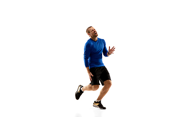 Image showing Caucasian professional runner, jogger training isolated on white studio background in fire