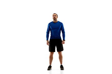 Image showing Caucasian professional runner, jogger training isolated on white studio background in fire