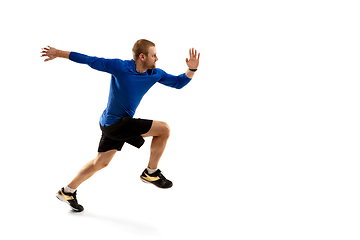 Image showing Caucasian professional runner, jogger training isolated on white studio background in fire