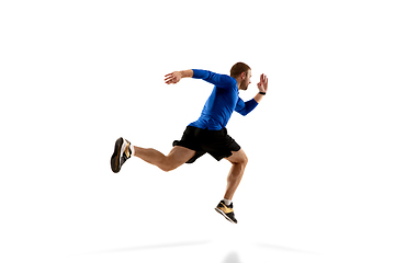 Image showing Caucasian professional runner, jogger training isolated on white studio background in fire