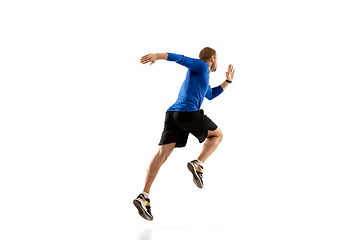 Image showing Caucasian professional runner, jogger training isolated on white studio background in fire