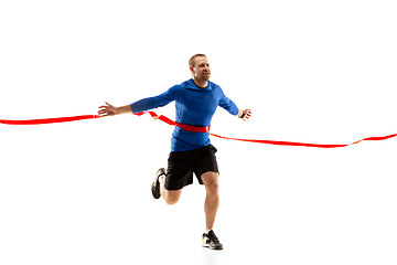 Image showing Caucasian professional runner, jogger training isolated on white studio background in fire