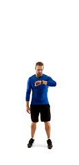 Image showing Caucasian professional runner, jogger training isolated on white studio background in fire