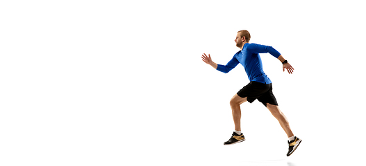 Image showing Caucasian professional runner, jogger training isolated on white studio background in fire