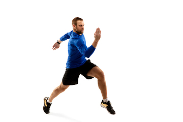 Image showing Caucasian professional runner, jogger training isolated on white studio background in fire