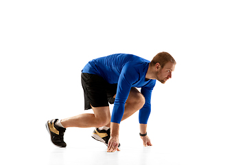 Image showing Caucasian professional runner, jogger training isolated on white studio background in fire