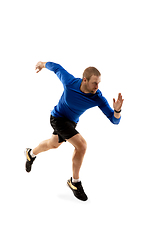 Image showing Caucasian professional runner, jogger training isolated on white studio background in fire