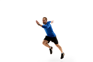 Image showing Caucasian professional runner, jogger training isolated on white studio background in fire