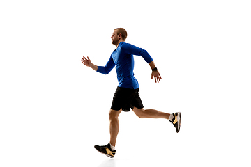 Image showing Caucasian professional runner, jogger training isolated on white studio background in fire