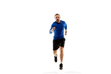 Image showing Caucasian professional runner, jogger training isolated on white studio background in fire