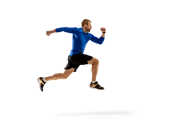 Image showing Caucasian professional runner, jogger training isolated on white studio background in fire