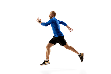 Image showing Caucasian professional runner, jogger training isolated on white studio background in fire