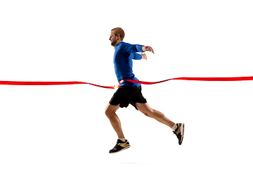 Image showing Caucasian professional runner, jogger training isolated on white studio background in fire