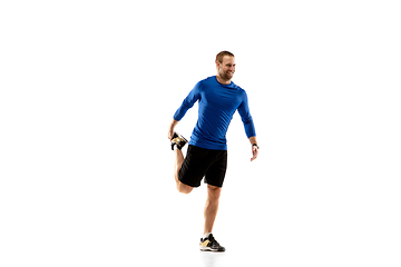 Image showing Caucasian professional runner, jogger training isolated on white studio background in fire