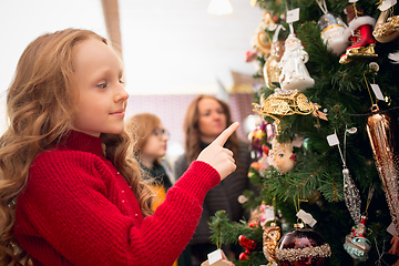 Image showing Smiling family, mother and kids looking for home decoration and holiday\'s gifts in household store