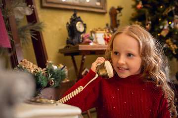 Image showing Cheerful little girl looking for home decoration and holiday\'s gifts in household store