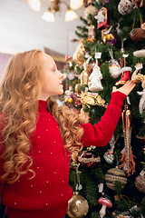 Image showing Cheerful little girl looking for home decoration and holiday\'s gifts in household store