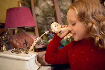 Image showing Cheerful little girl looking for home decoration and holiday\'s gifts in household store