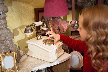 Image showing Cheerful little girl looking for home decoration and holiday\'s gifts in household store