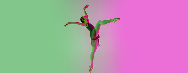 Image showing Young and graceful ballet dancer isolated on gradient pink-green studio background in neon light. Art in motion