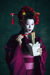 Image showing Young japanese woman as geisha on dark green background. Retro style, comparison of eras concept.