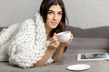 Image showing Portrait of beautiful woman isolated on white studio background. Comfort, warm in winter concept