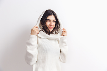 Image showing Portrait of beautiful woman isolated on white studio background. Comfort, warm in winter concept