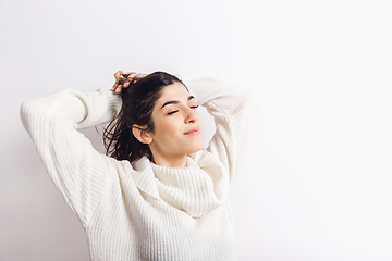 Image showing Portrait of beautiful woman isolated on white studio background. Comfort, warm in winter concept