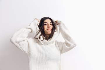 Image showing Portrait of beautiful woman isolated on white studio background. Comfort, warm in winter concept