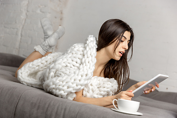 Image showing Portrait of beautiful woman isolated on white studio background. Comfort, warm in winter concept