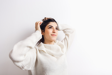 Image showing Portrait of beautiful woman isolated on white studio background. Comfort, warm in winter concept