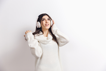 Image showing Portrait of beautiful woman isolated on white studio background. Comfort, warm in winter concept