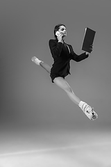 Image showing Young fashionable, stylish woman wearing jacket and socks working from home. Fashion during insulation \'cause of coronavirus pandemic