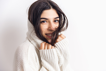 Image showing Portrait of beautiful woman isolated on white studio background. Comfort, warm in winter concept