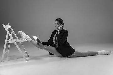 Image showing Young fashionable, stylish woman wearing jacket and socks working from home. Fashion during insulation \'cause of coronavirus pandemic