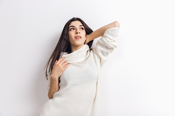 Image showing Portrait of beautiful woman isolated on white studio background. Comfort, warm in winter concept