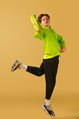 Image showing Old-school fashioned young man dancing isolated on yellow background