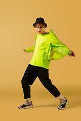 Image showing Old-school fashioned young man dancing isolated on yellow background