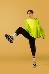 Image showing Old-school fashioned young man dancing isolated on yellow background