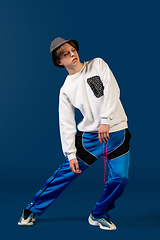 Image showing Old-school fashioned young man dancing isolated on blue background