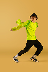 Image showing Old-school fashioned young man dancing isolated on yellow background