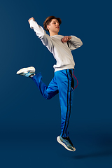 Image showing Old-school fashioned young man dancing isolated on blue background